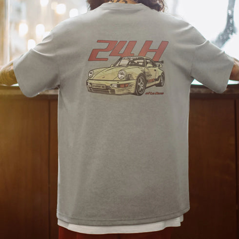Person wearing a gray t-shirt with a car graphic and '24H' text on the back.